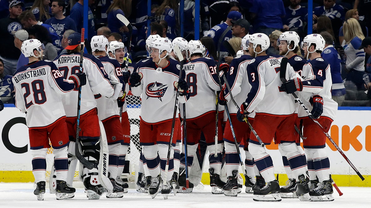 The Columbus Blue Jackets celebrates their 4-3 win over the Tampa Bay Lightning during Game 1 of an NHL Eastern Conference first-round hockey playoff series Wednesday, April 10, 2019, in Tampa, Fla. (AP Photo/Chris O'Meara)