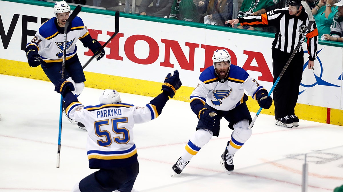 St. Louis Blues' Tyler Bozak (21), Colton Parayko (55) and Pat Maroon (7) celebrate a goal by Maroon against the Dallas Stars in the third period of Game 3 of an NHL second-round hockey playoff series in Dallas, Monday, April 29, 2019. (AP Photo/Tony Gutierrez)