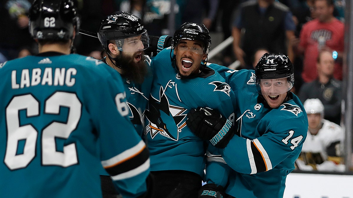 From left, San Jose Sharks' Kevin Labanc (62), Brent Burns, Evander Kane, and Gustav Nyquist (14) celebrate a goal by Joe Pavelski, not seen, against the Vegas Golden Knights during the first period of Game 1 of an NHL hockey first-round playoff series Wednesday, April 10, 2019, in San Jose, Calif. (AP Photo/Ben Margot)