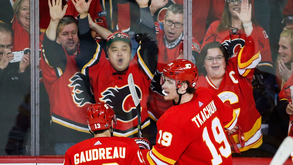 Calgary Flames' Matthew Tkachuk, right, celebrates his goal against the Colorado Avalanche during the second period of Game 1 in an NHL hockey first-round playoff series Thursday, April 11, 2019, in Calgary, Alberta. (Jeff McIntosh/The Canadian Press via AP)