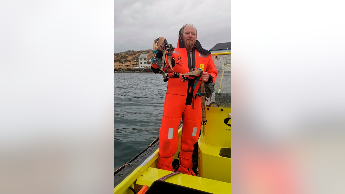 Norwegian Joergen Ree Wiig holds the whale harness after it was removed from a beluga whale off the northern Norwegian coast Friday, April 26, 2019.