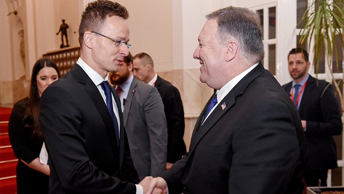 U.S. Secretary of State Mike Pompeo is welcomed by Hungary's Minister of Foreign Affairs and Trade Peter Szijjarto in the ministry building in Budapest, Hungary, February 11, 2019. (Attila Kisbenedek/Pool via Reuters)