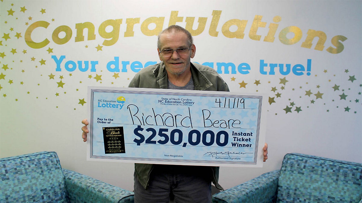 Richard Beare collected his big prize from the winning scratch-off ticket Monday.