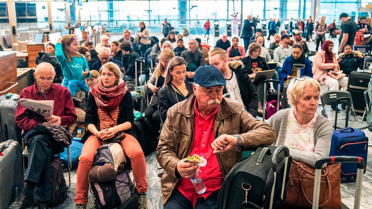 Travellers wait during a strike of Scandinavian Airlines' (SAS) pilots on April 26, 2019 at the Gardamoen Airport in Oslo, Norway.