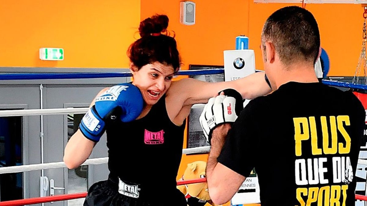 Iranian boxer Sadaf Khadem (L) trains with French Iranian former world boxing champion Mahyar Monshipour in a gymnasium in Royan, southwestern France, on April 11, 2019 ahead of her first fight.