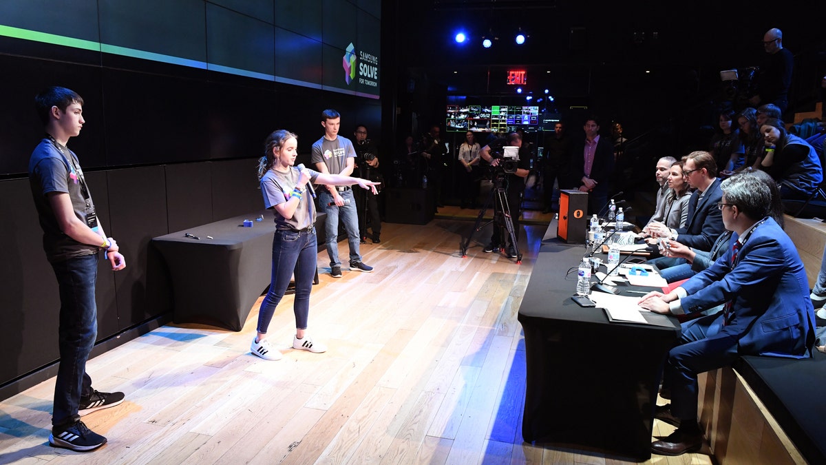 Students Jonah Hoffman, Paige Tayloe and Trey Fisher of Owensville High School in Owensville, Missouri present their STEM project to judges at the Samsung Solve for Tomorrow National Finalist Pitch Event on Monday, April 1, 2019 in New York City (Samsung)