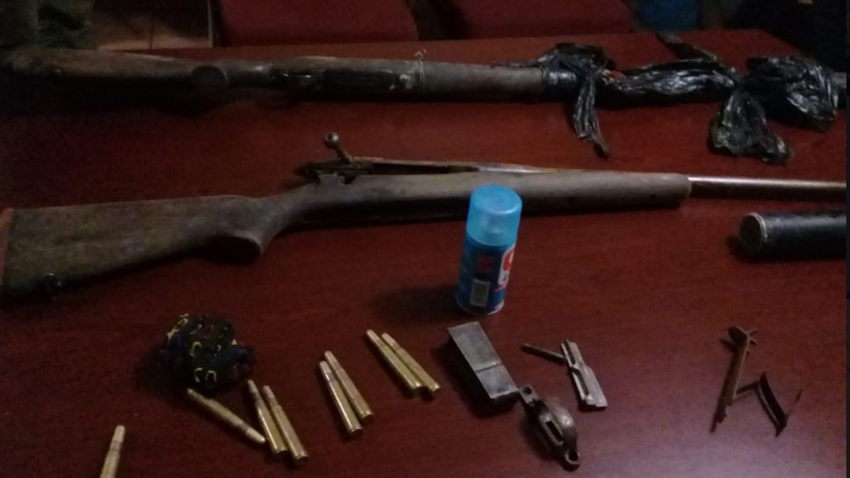 Rifles and ammunition were discovered after a poacher was reportedly killed by an elephant.