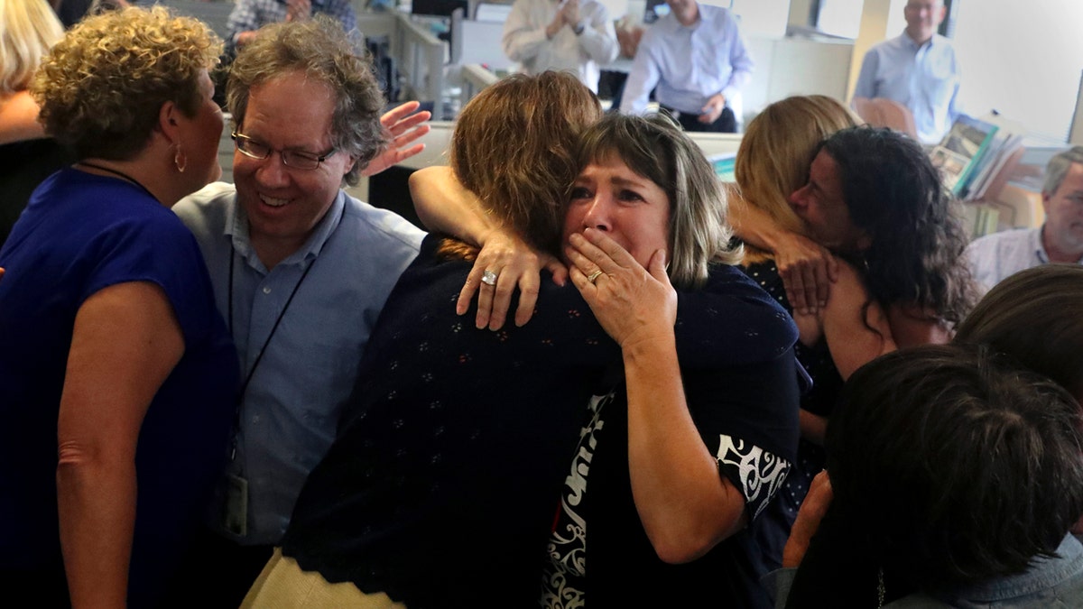 South Florida Sun Sentinel staffers react after winning the Pulitzer Prize for Public Service Monday for its coverage of the Parkland school shooting. (Carline Jean/South Florida Sun-Sentinel via AP)