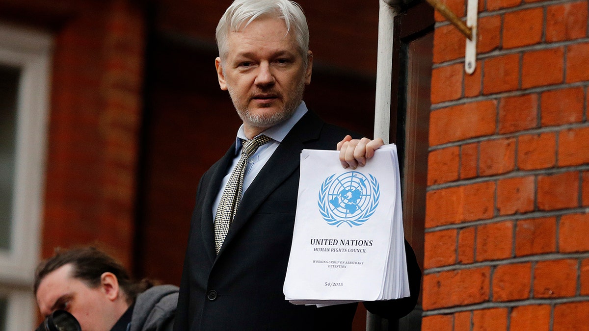 FILE - In this Friday, Feb. 5, 2016 file photo, WikiLeaks founder Julian Assange stands on the balcony of the Ecuadorean Embassy to address waiting supporters and media in London. (AP Photo/Frank Augstein, File)