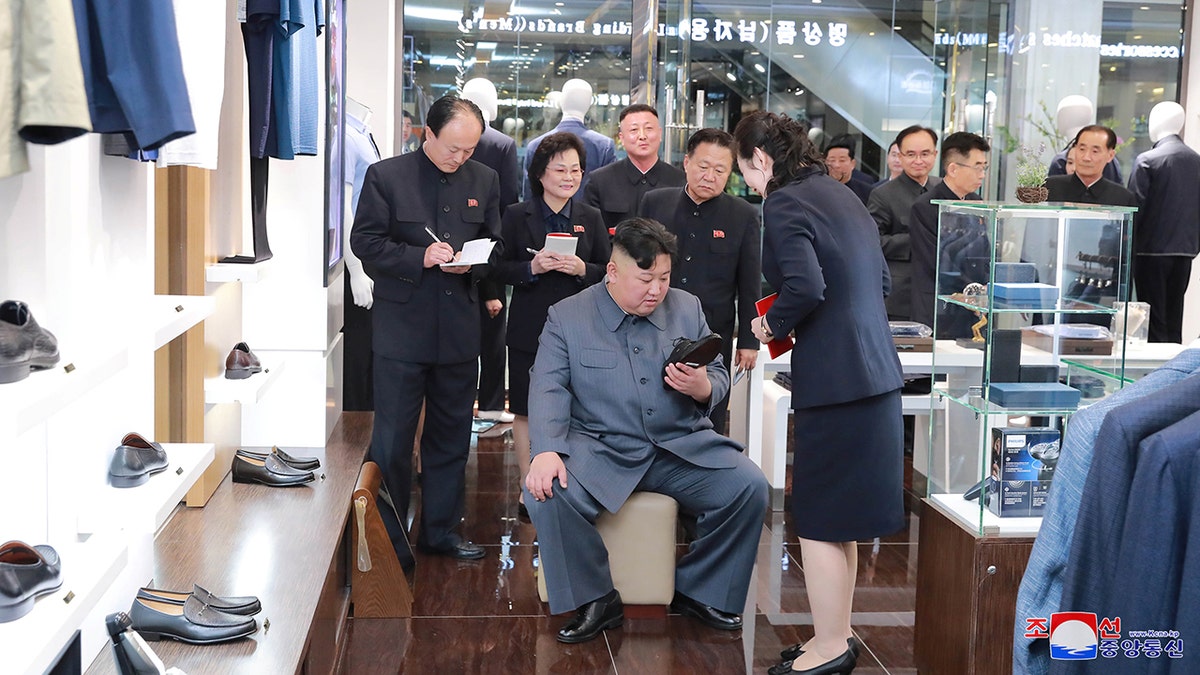 Kim Jong Un inspecting a shoe during his visit to Taesong Department Store in Pyongyang.