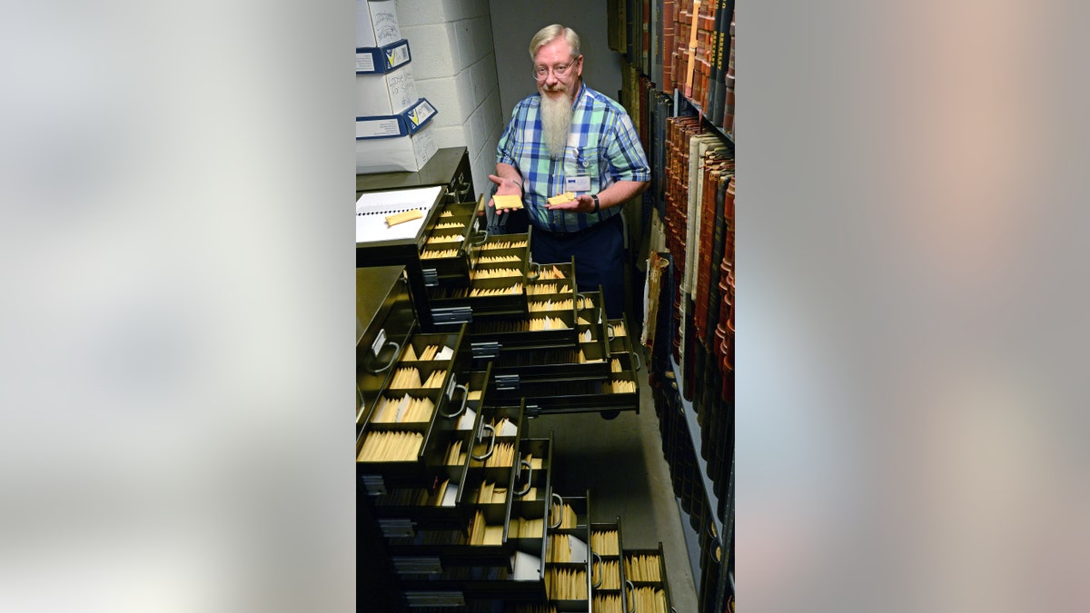 Historian Randy Marcum and the unclaimed medals at the West Virginia State Archives.