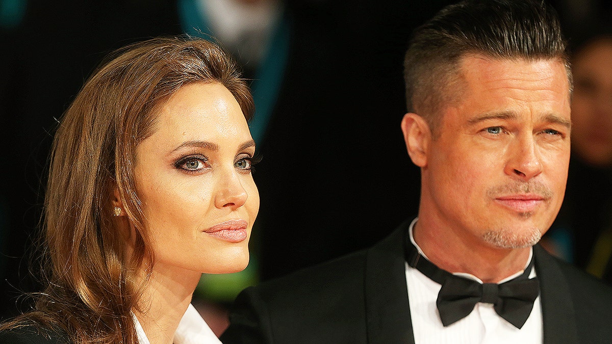 Angelina Jolie and Brad Pitt pose for a photo
