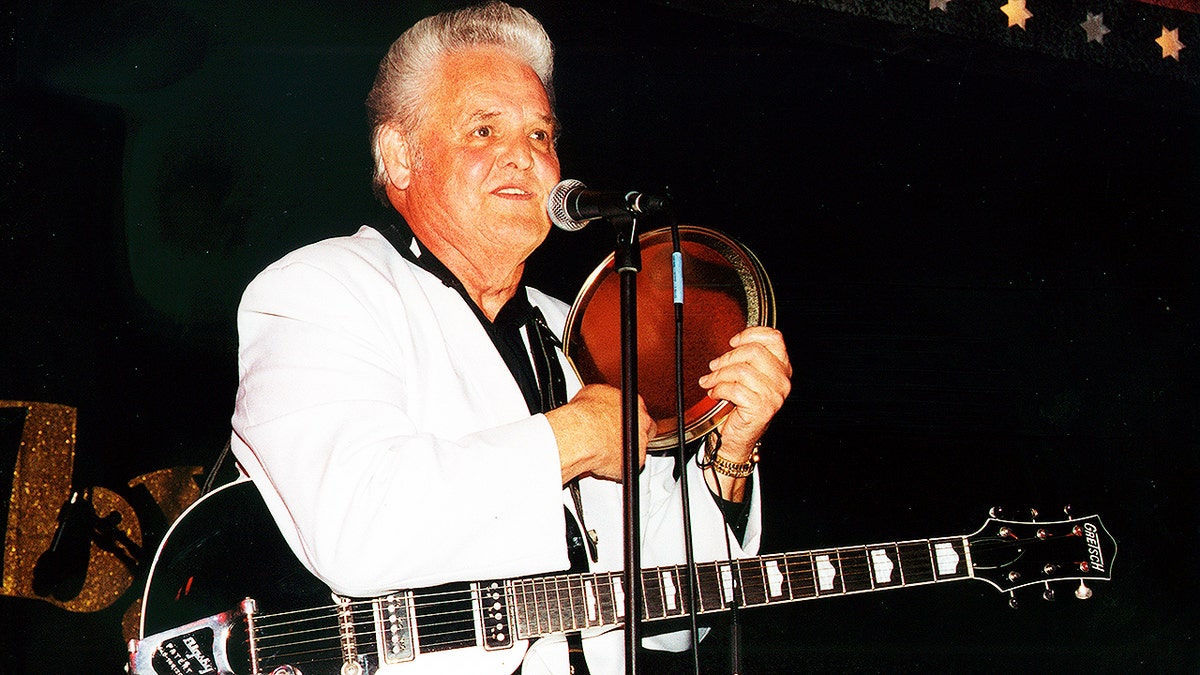This 2002 photo released by Redbush Classics Records shows rockabilly Hall of Famer Billy Adams performing in Hemsby, England. Adams, who wrote and recorded a rockabilly staple “Rock, Pretty Mama,” died Saturday, March 30, 2019, in Westmoreland, Tenn. He was 79. (Redbush Classics Records via AP)