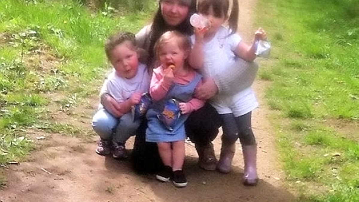 Cleo, pictured center with her mom and siblings, is currently receiving chemotherapy to shrink the tumor before she undergoes surgery to remove it.