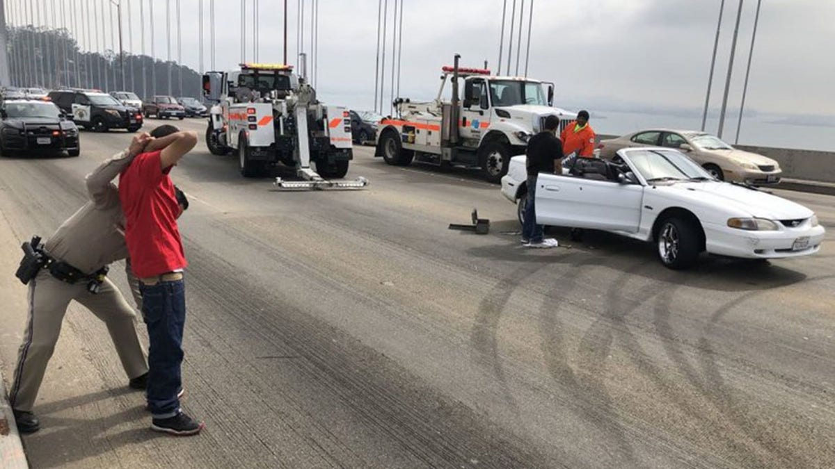 Police arrest a sideshow performer in Oakland, Calif., last year. 