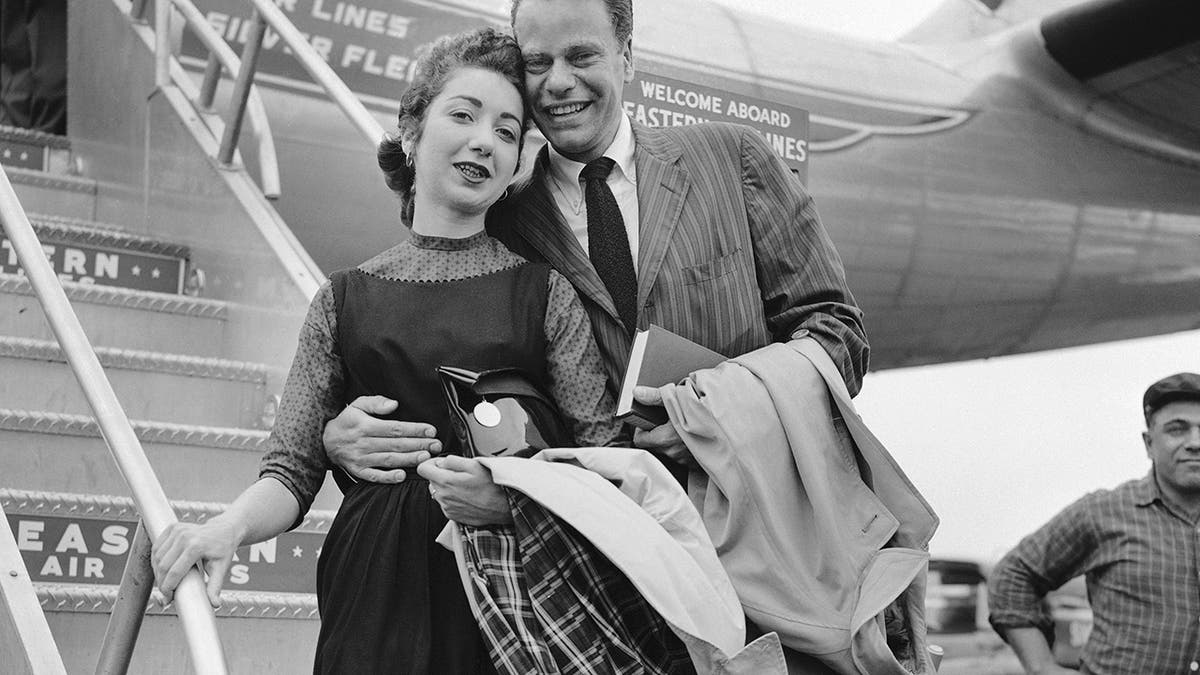 In this April 2, 1957 file photo, Charles Van Doren and his bride, the former Geraldine Ann Bernstein, arrive from their Puerto Rican honeymoon at the former Idlewild Airport in New York. 