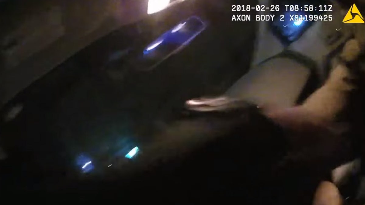 Groton Officer Tyler DeAngelo can be seen struggling to stay in a car as a suspect drove away in February 2018.