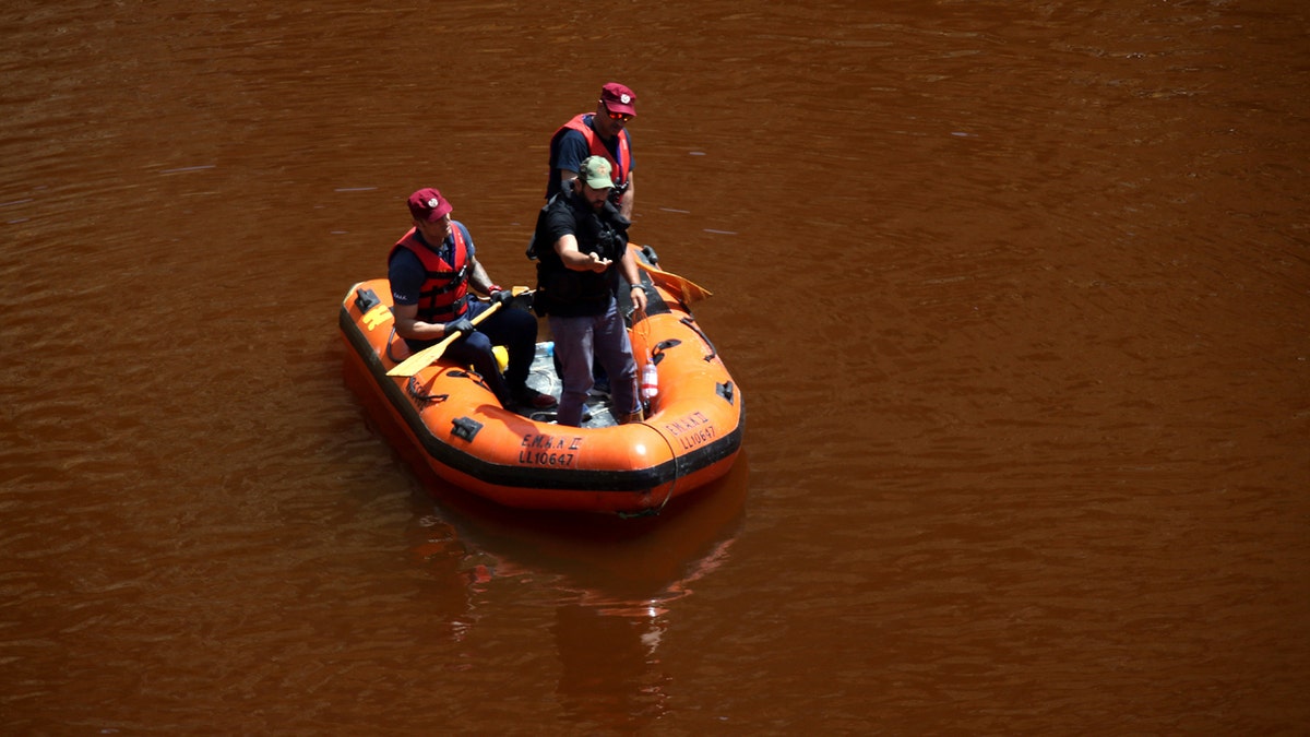 Members of the Cyprus Special Disaster Response Unit search for a suitcase in a man-made lake, near the village of Mitsero outside of the capital Nicosia, Cyprus, Monday April 29, 2019.