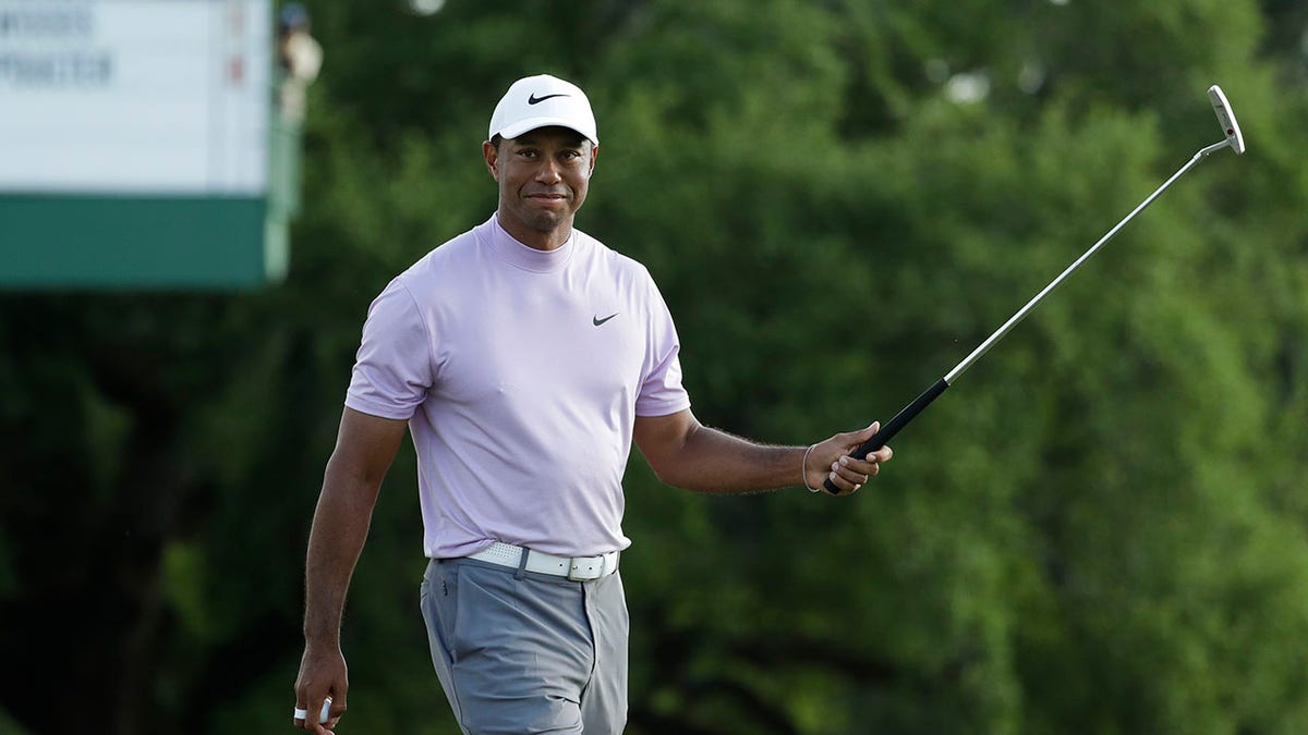 Tiger Woods smiles as he walks off the 18th green during the third round for the Masters golf tournament Saturday, April 13, 2019, in Augusta, Ga. (Associated Press)