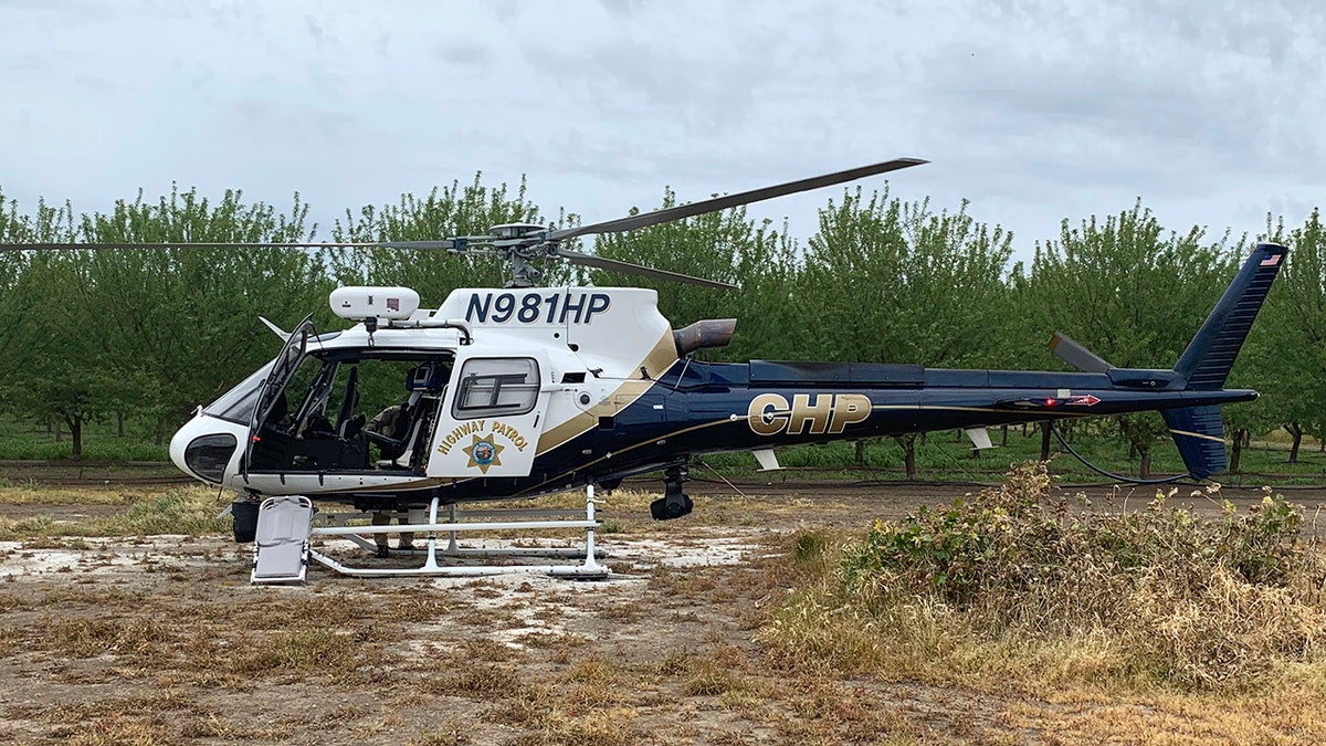 A CHP helicopter is stationed near where two teenage boys were electrocuted while trying to rescue a dog from an irrigation canal at an orchard in Dixon, Calif. (California Highway Patrol/Via AP)