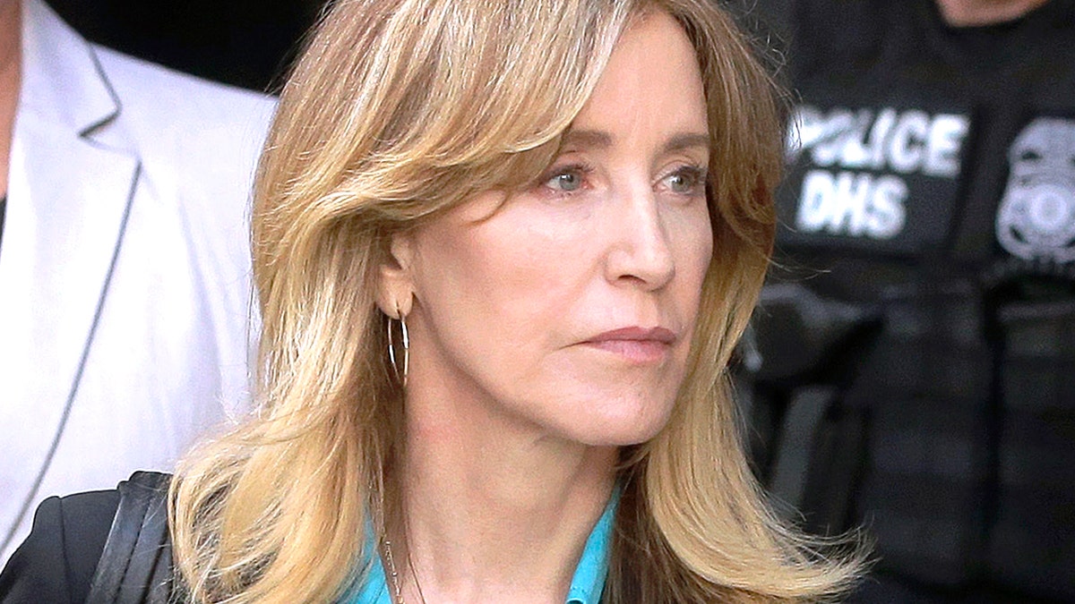 FILE - In this April 3, 2019 file photo, actress Felicity Huffman arrives at federal court in Boston to face charges in a nationwide college admissions bribery scandal. In a court filing on Monday, April 8, 2019, Huffman agreed to plead guilty in the cheating scam. (AP Photo/Steven Senne, File)