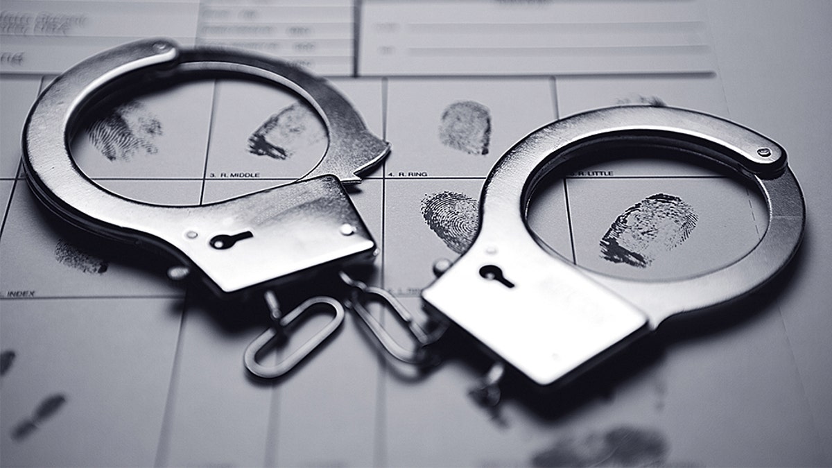 photo shows handcuffs and constabulary fingerprint pad
