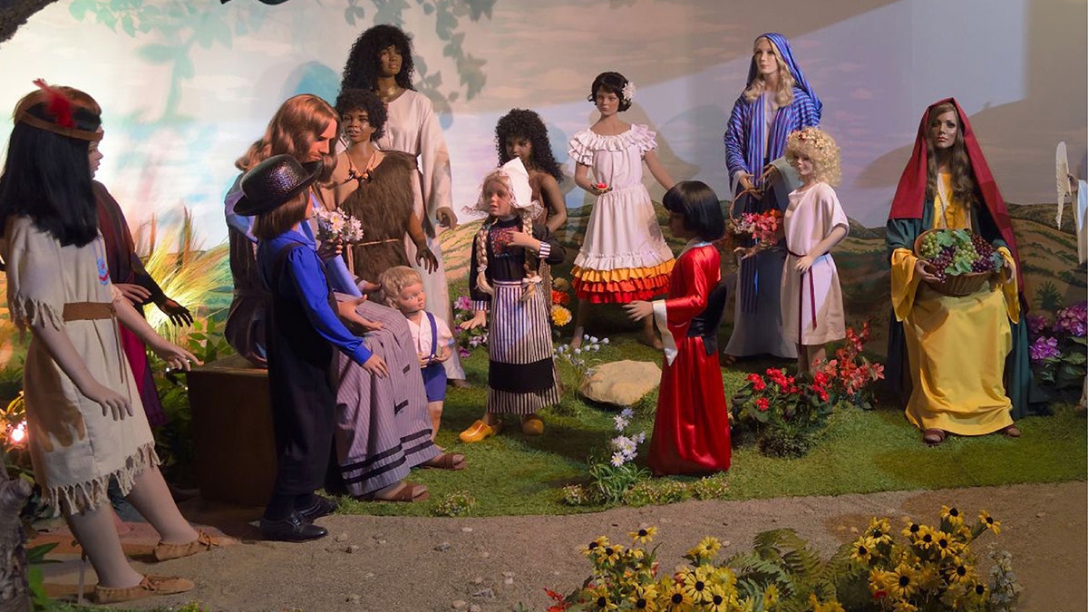 Visitors interact with the scene of Jesus and the little children at the BibleWalk wax museum in Mansfield, Ohio.