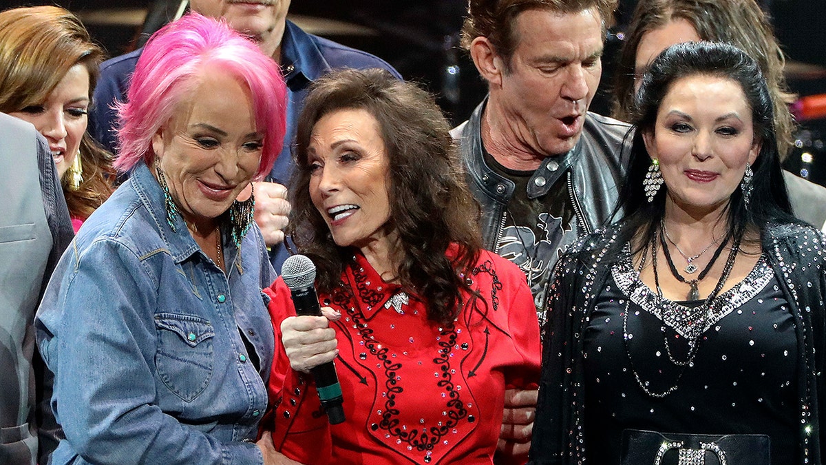 Loretta Lynn, center, Tanya Tucker, left, and Crystal Gayle perform at Loretta Lynn's 87th Birthday Tribute at Bridgestone Arena on Monday, April 1, 2019, in Nashville, Tenn. (Photo by Al Wagner/Invision/AP)