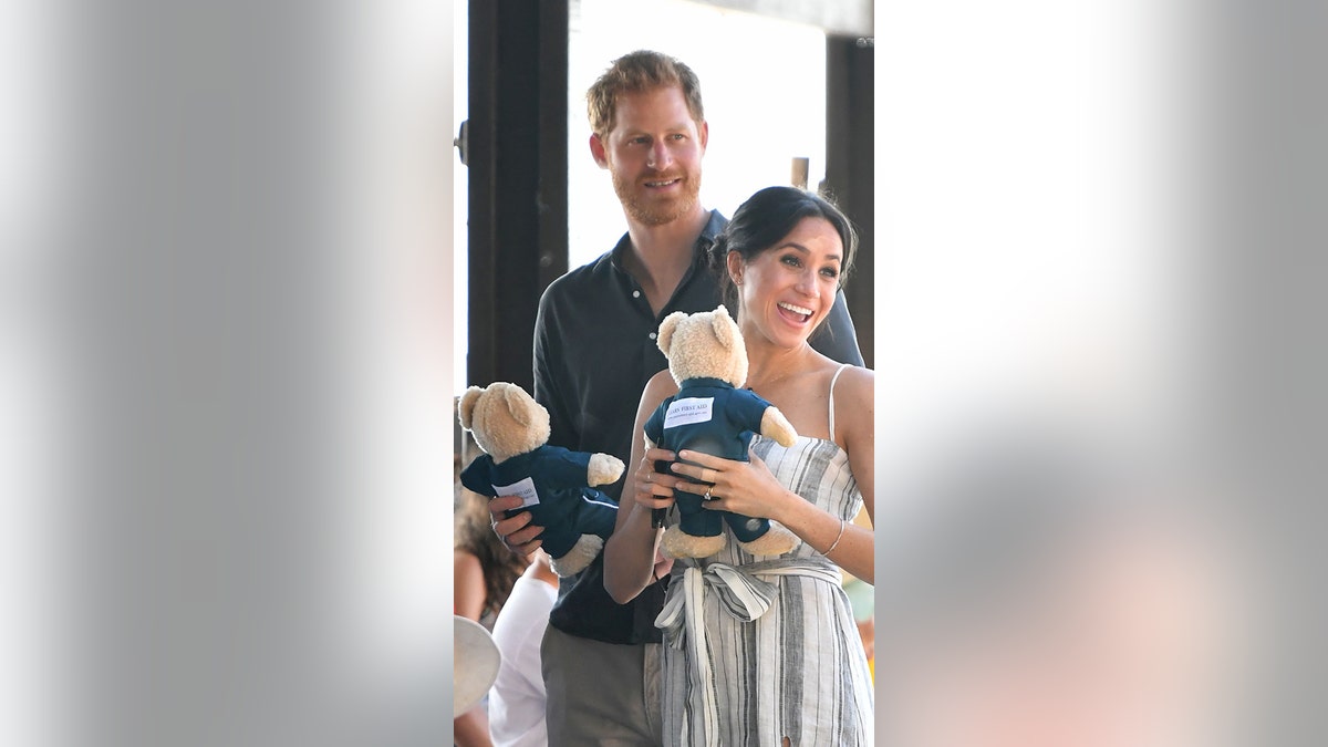 Britain's Prince Harry and his wife Meghan, the Duchess of Sussex attend a meet-the-people walk at Kingfisher Bay Resort on Fraser Island on October 22, 2018. Prince Harry greeted an Aboriginal community on the stunning World Heritage-listed Fraser Island on October 22 as his pregnant wife Meghan took a break from official duties during the royal couple's Australian tour.