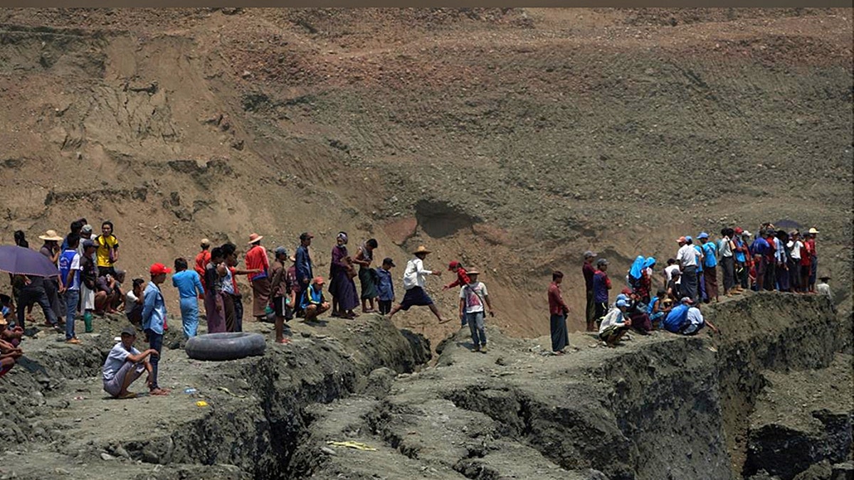 Local people look on in a jade mine where the mud dam collapsed in Hpakant, Kachin state, Myanmar April 23, 2019.