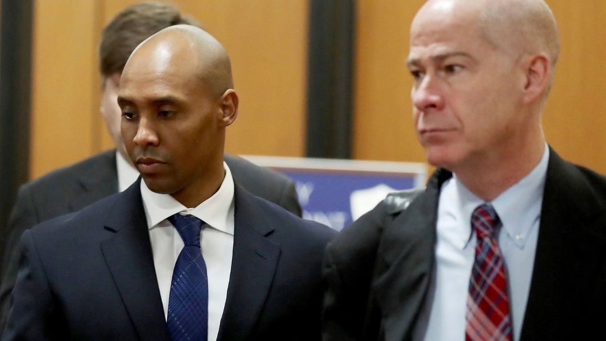 Former Minneapolis police officer Mohamed Noor, center, is accompanied by his attorneys Peter Wold, not pictured, and Thomas Plunkett, right, as he walks towards the Hennepin County Government Center for opening arguments of his trial Tuesday, April 9, 2019.
