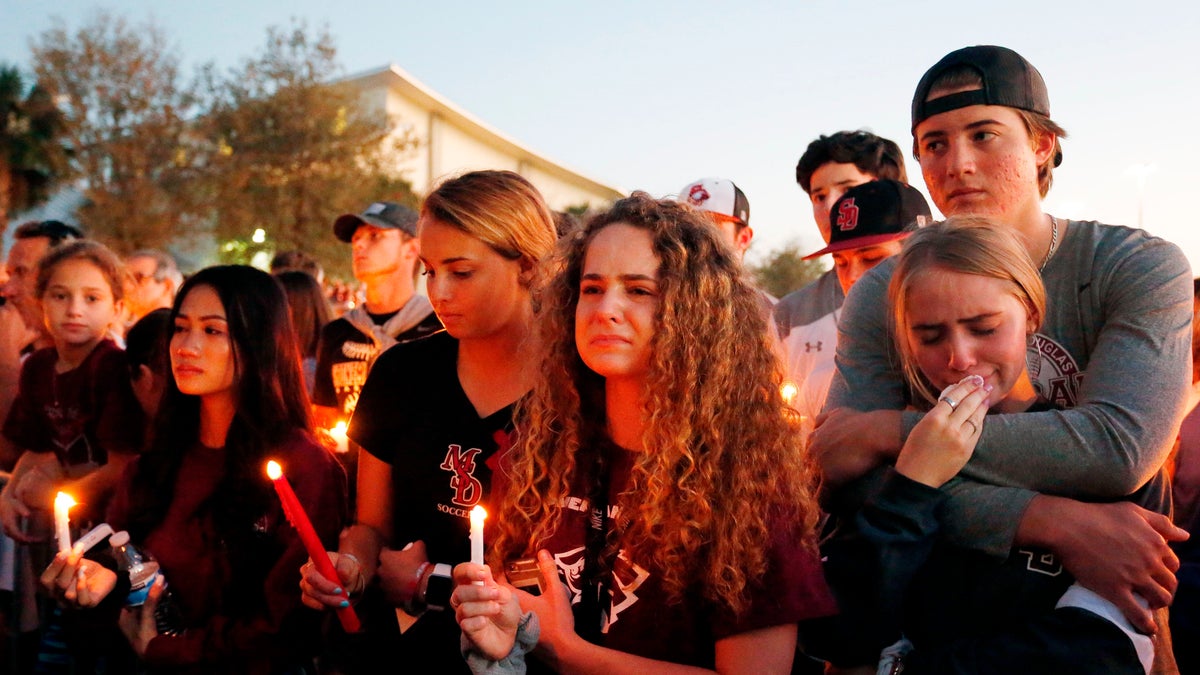 Mourners react during a candlelight vigil for the victims of the Marjory Stoneman Douglas High School shooting in Parkland, Florida on February 15, 2018. (RHONA WISE/AFP/Getty Images)