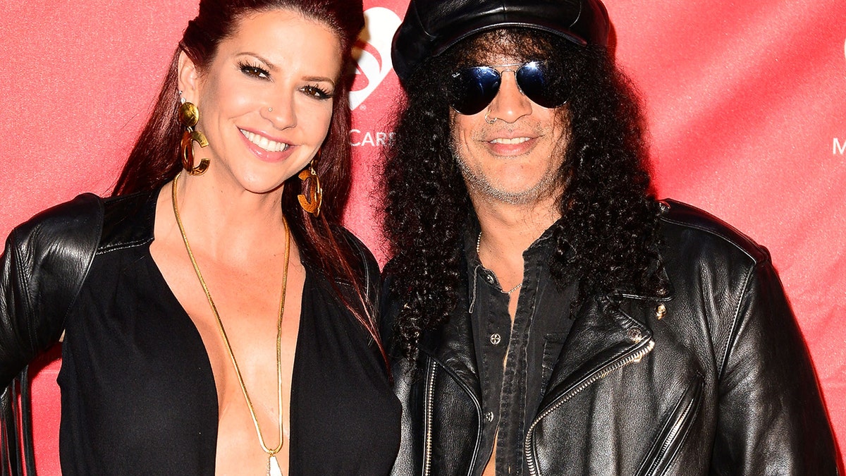Musician Slash, right, and now-ex-wife Perla Hudson arrive at the 2014 MusiCares MAP Fund Benefit Concert at Club Nokia on May 12, 2014 in Los Angeles, California. (Jerod Harris/WireImage)