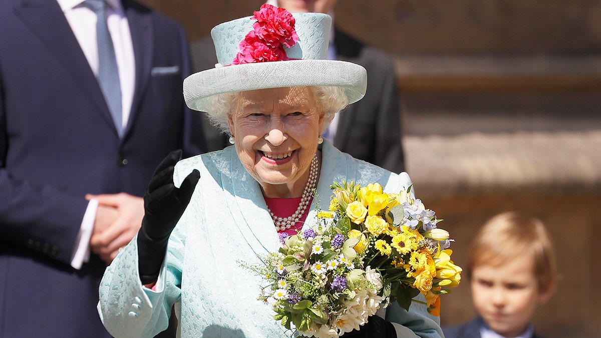Britain's Queen Elizabeth II waves to the public as she leaves after attending the Easter Mattins Service at St. George's Chapel, at Windsor Castle in England Sunday, April 21, 2019. (AP Photo/Kirsty Wigglesworth, pool)