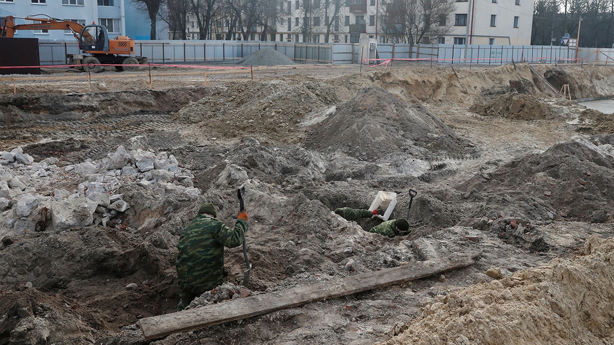 Soldiers from a special "search battalion" of Belarus Defence Ministry take part in the exhumation of a mass grave containing the remains of about 730 prisoners of a former Jewish ghetto, discovered at a construction site in the center of Brest, Belarus February 26, 2019.