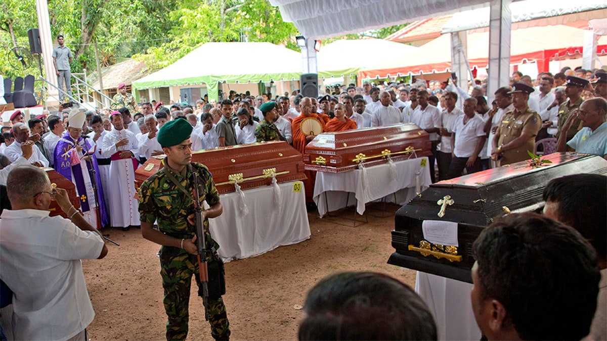 A soldier stands guard during a funeral service attended by Cardinal Malcolm Ranjith for Easter Sunday bomb blast victims at St. Sebastian Church in Negombo, Sri Lanka, on Tuesday. (AP)