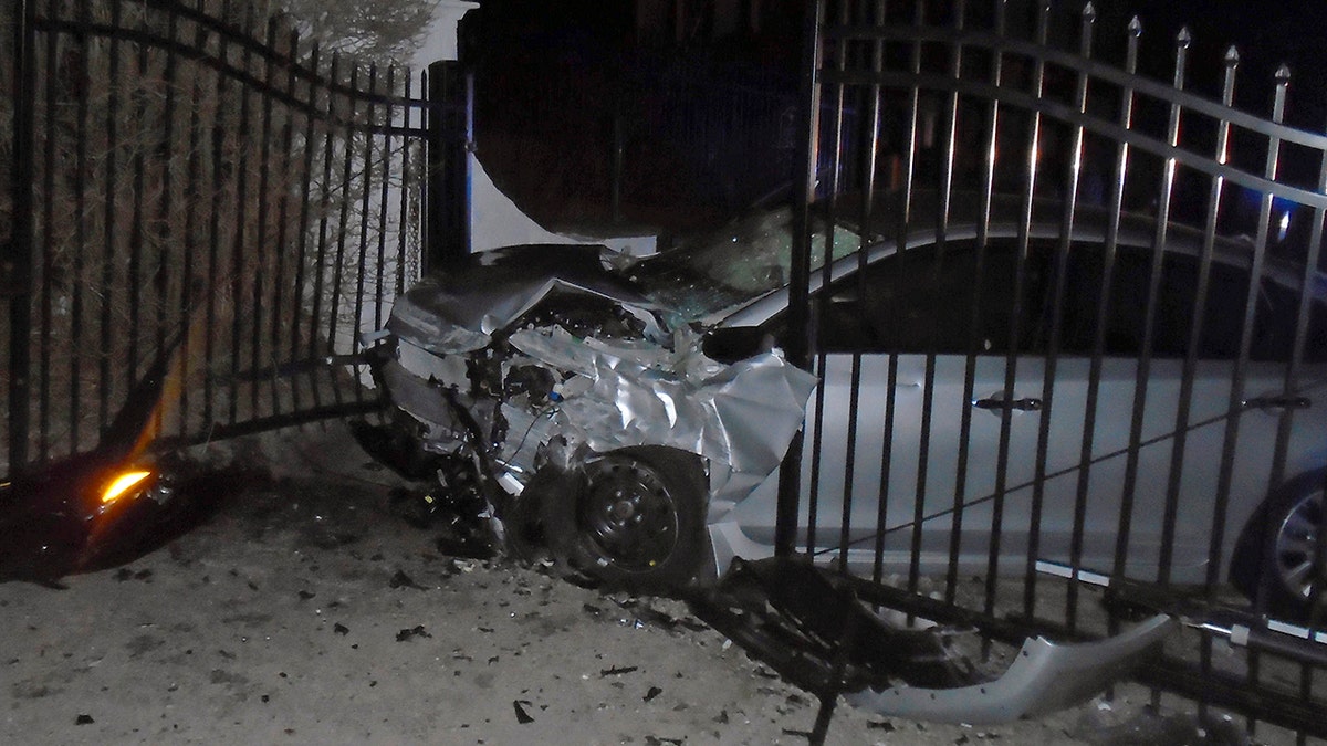 This Tuesday, April 2, 2019 photo released by the Hopkinton, R.I., Police Department shows a car after it crashed into the gates of singer Taylor Swift's beachfront home in Westerly, R.I. Police said the car was stolen in Hartford, Conn., and that officers from Hopkinton and Westerly pursued the vehicle with four occupants around 1 a.m. Tuesday. (Hopkinton Police Department via AP)