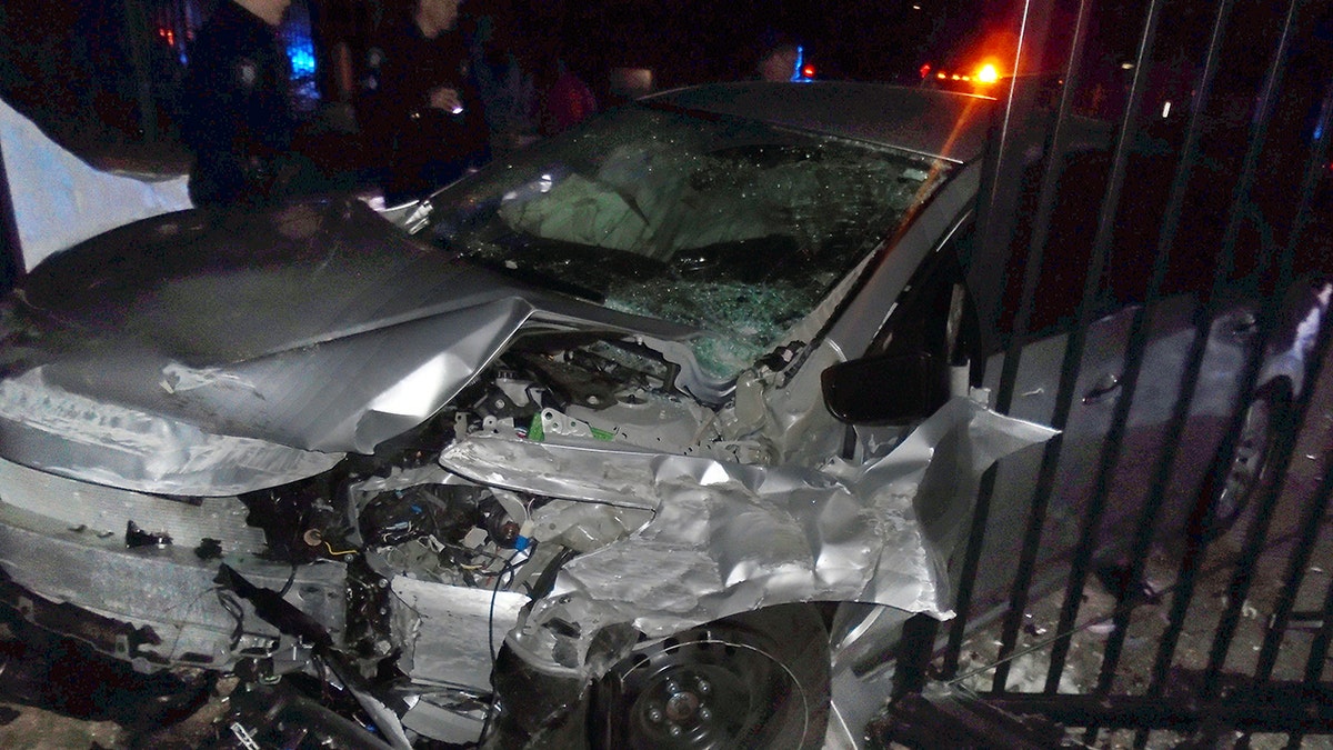 This Tuesday, April 2, 2019 photo released by the Hopkinton, R.I., Police Department shows a car after it crashed into the gates of singer Taylor Swift's beachfront home in Westerly, R.I. Police said the car was stolen in Hartford, Conn., and that officers from Hopkinton and Westerly pursued the vehicle with four occupants around 1 a.m. Tuesday. (Hopkinton Police Department via AP)