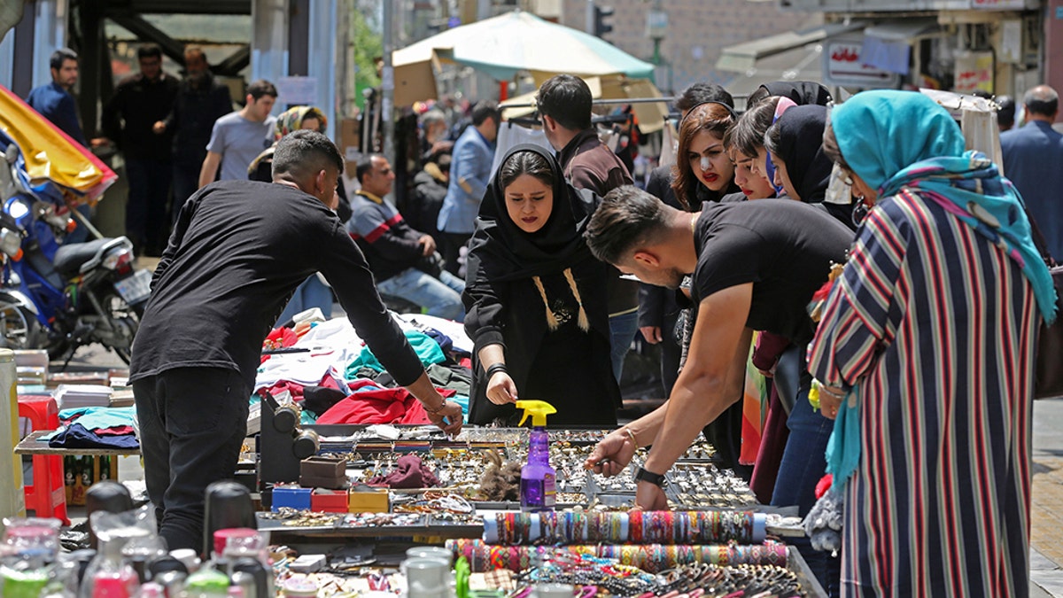 Iranians shop at an open market in the Islamic republic's capital Tehran, on April 24, 2019. - Iranians, already hard hit by punishing US economic sanctions, are bracing for more pain after Washington abolished waivers for some countries which had allowed them to buy oil from Iran.