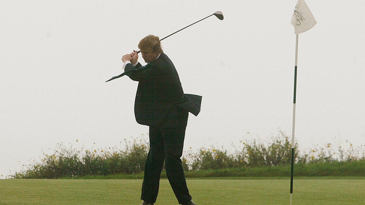 Donald Trump takes a swing on the 11th green of his newly acquired Ocean Trails Golf Club in Rancho Palos Verdes, Calif., Saturday, Nov. 9, 2002. (AP Photo/Damian Dovarganes)