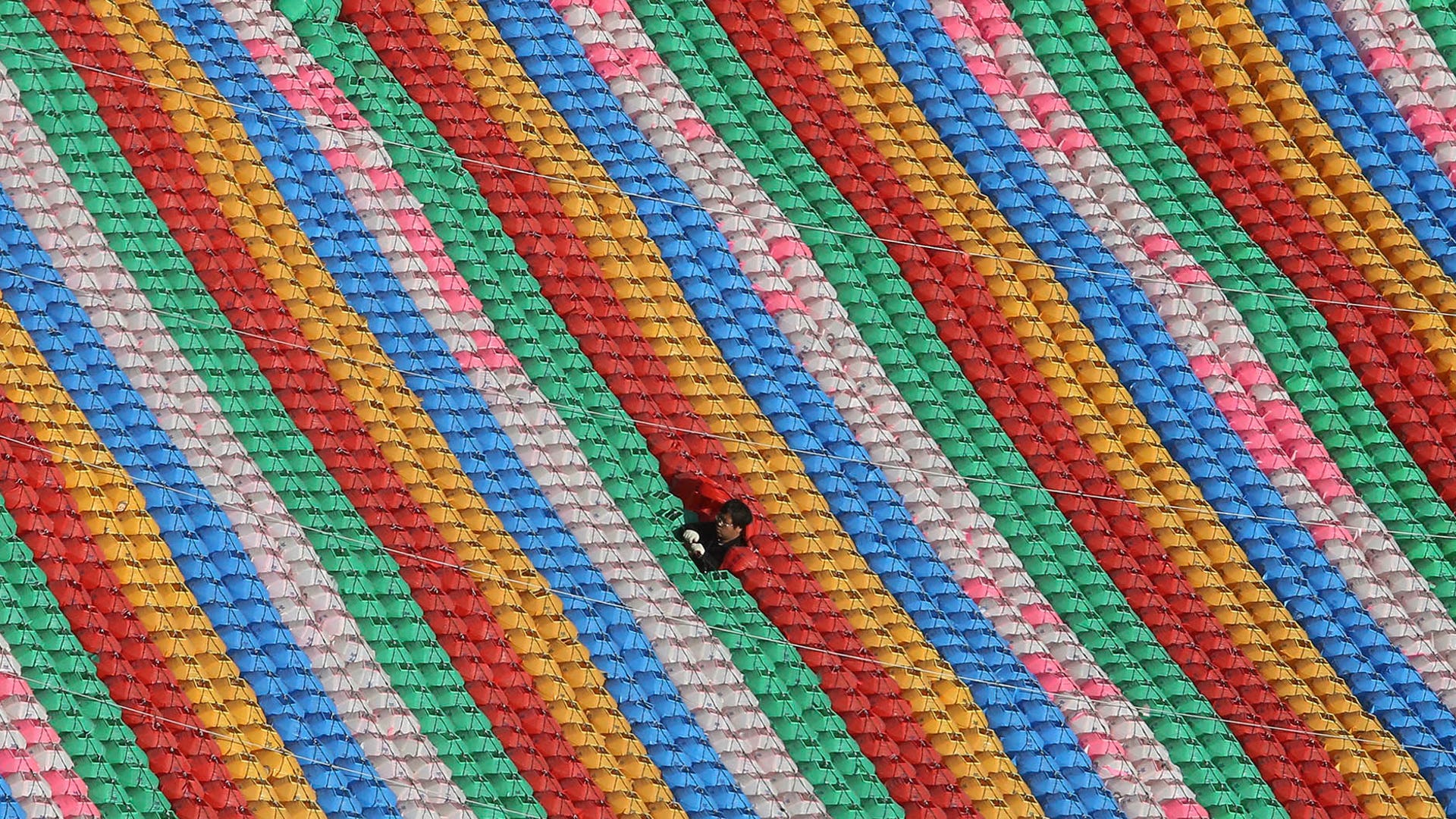 A worker adjusts lanterns for the upcoming celebration of Buddha's birthday at Jogye temple in Seoul, South Korea, April 8, 2019. 
