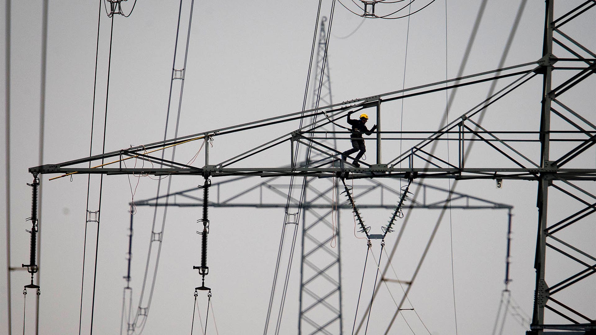 A technician works on high-voltage pylons in Frankfurt, Germany, April 9, 2019. 