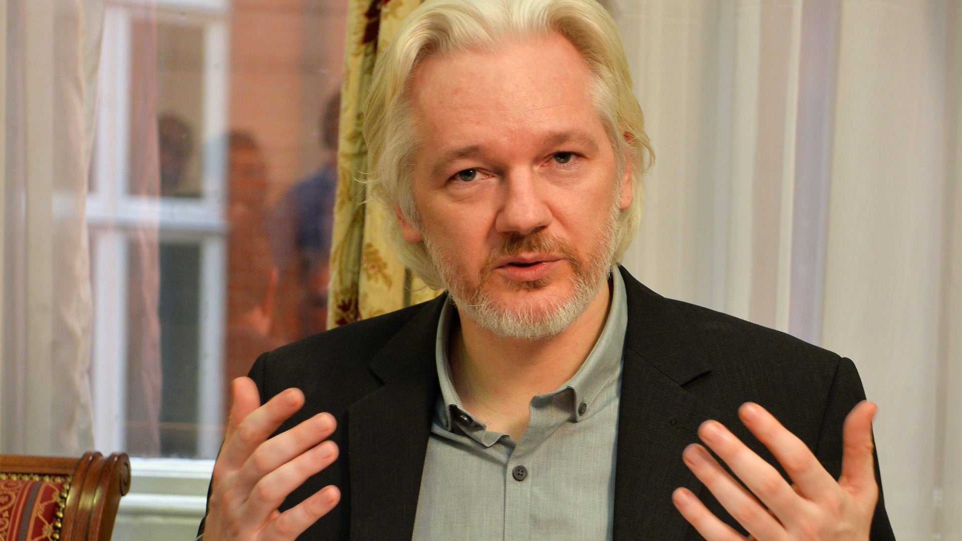 Assange speaks during a press conference inside the embassy, Aug. 18, 2014. 