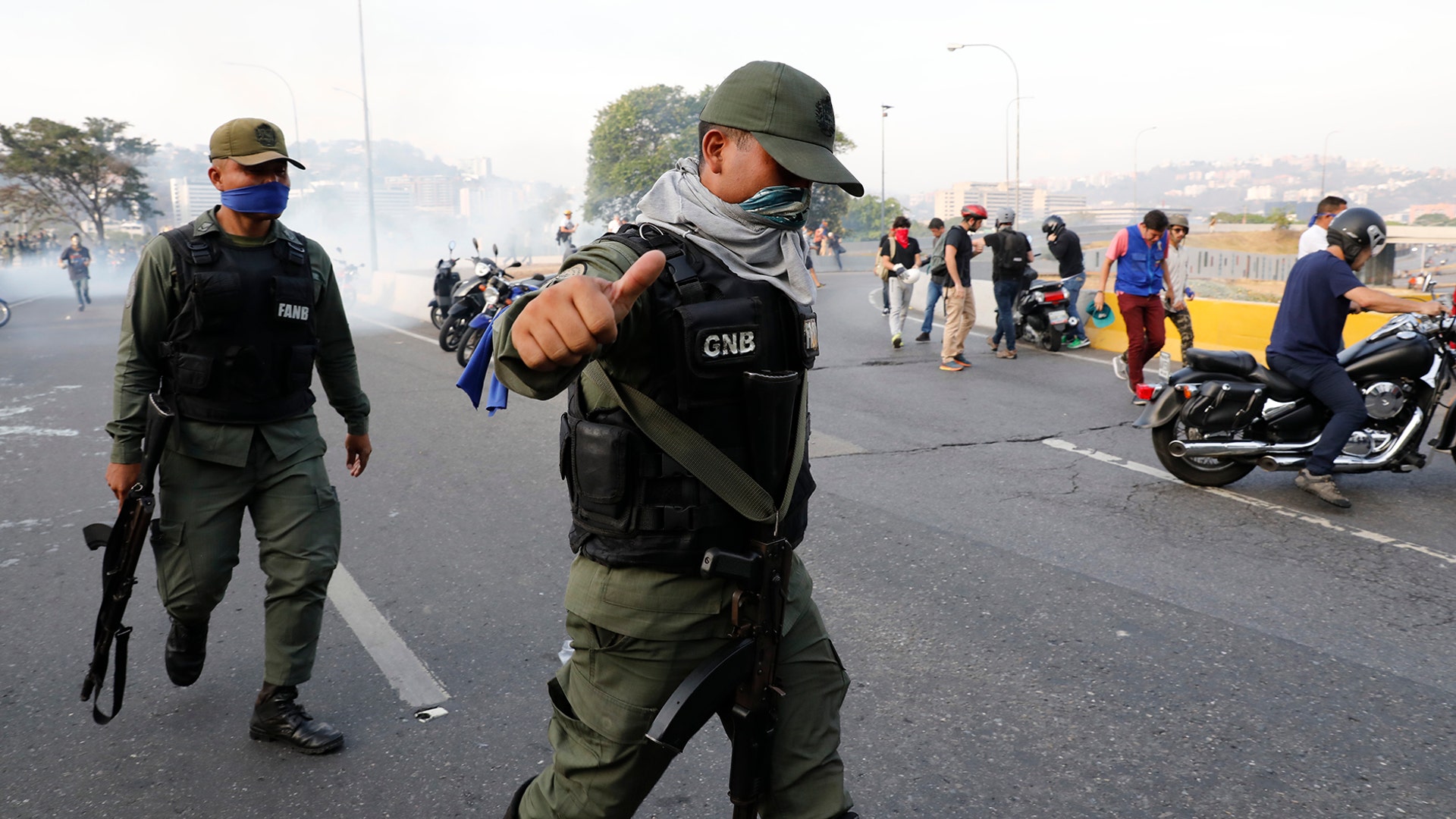 An uprising member of the Bolivarian National Guard gestures outside La Carlota air base in Caracas, Tuesday, April 30, 2019.