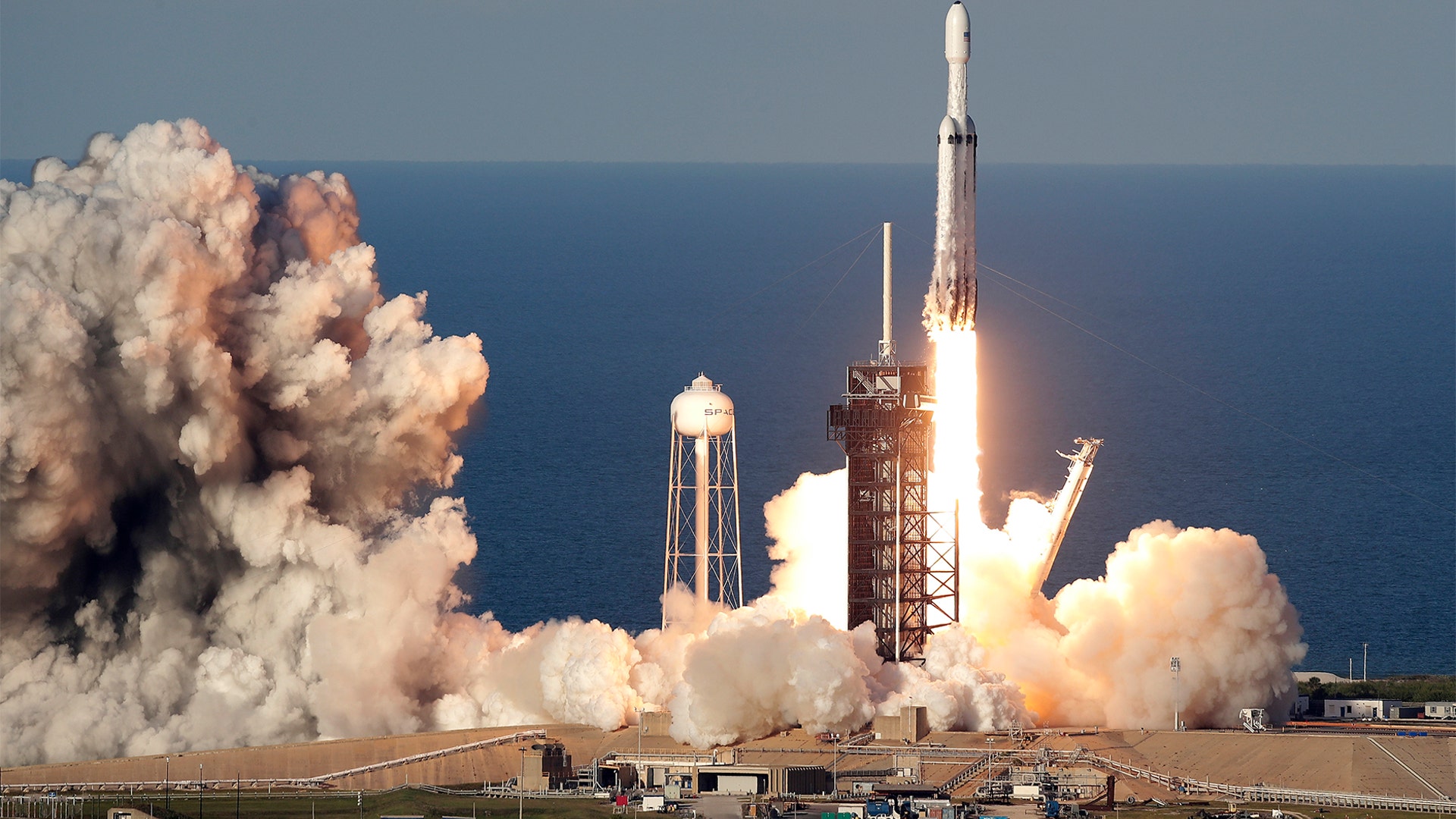 A SpaceX Falcon Heavy rocket carrying a communication satellite lifts off from pad 39A at the Kennedy Space Center in Cape Canaveral, Florida, April 11, 2019. 