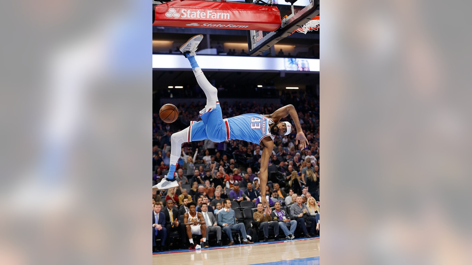Sacramento Kings Corey Brewer falls to the court after a dunk during the team's NBA basketball game against the Cleveland Cavaliers in Sacramento, April 4, 2019.