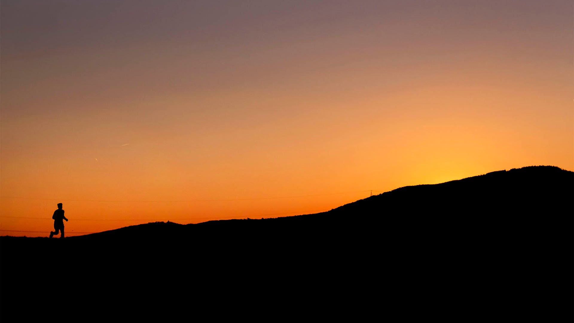 A man runs on a small road at sunset in Frankfurt, Germany, April 11, 2019. 