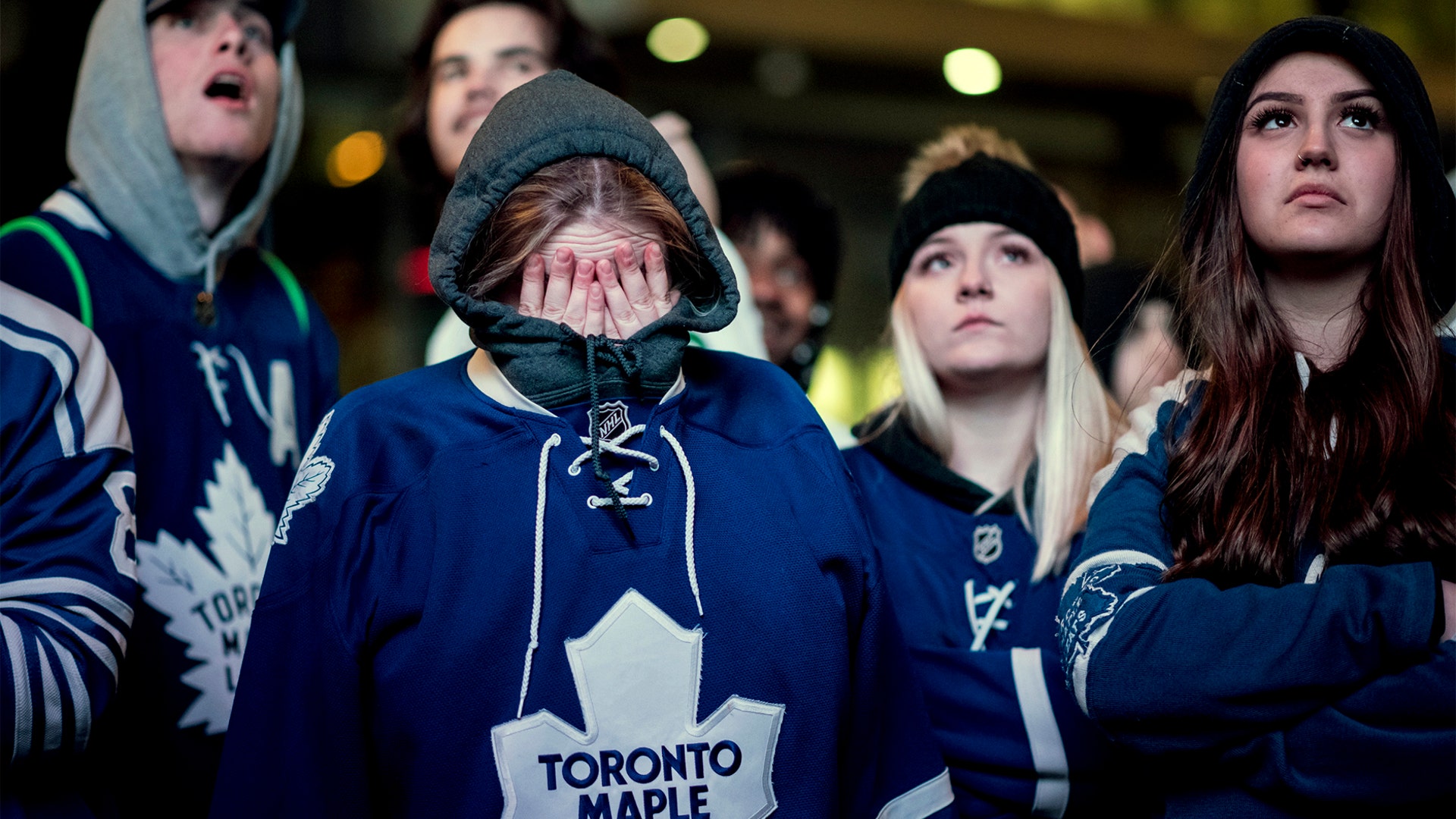 Fans react as they watch the Toronto Maple Leafs be eliminated from the Stanley Cup hockey playoffs by the Boston Bruins in Toronto, April 23, 2019. 