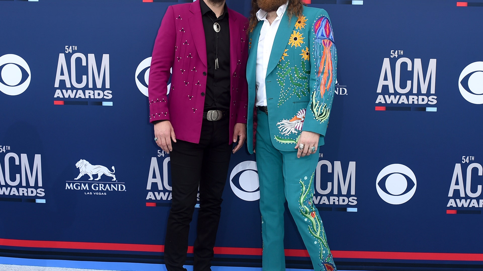 T.J. Osborne, left, and John Osborne, of Brothers Osborne, rock colorful suits to the 2019 ACMs.