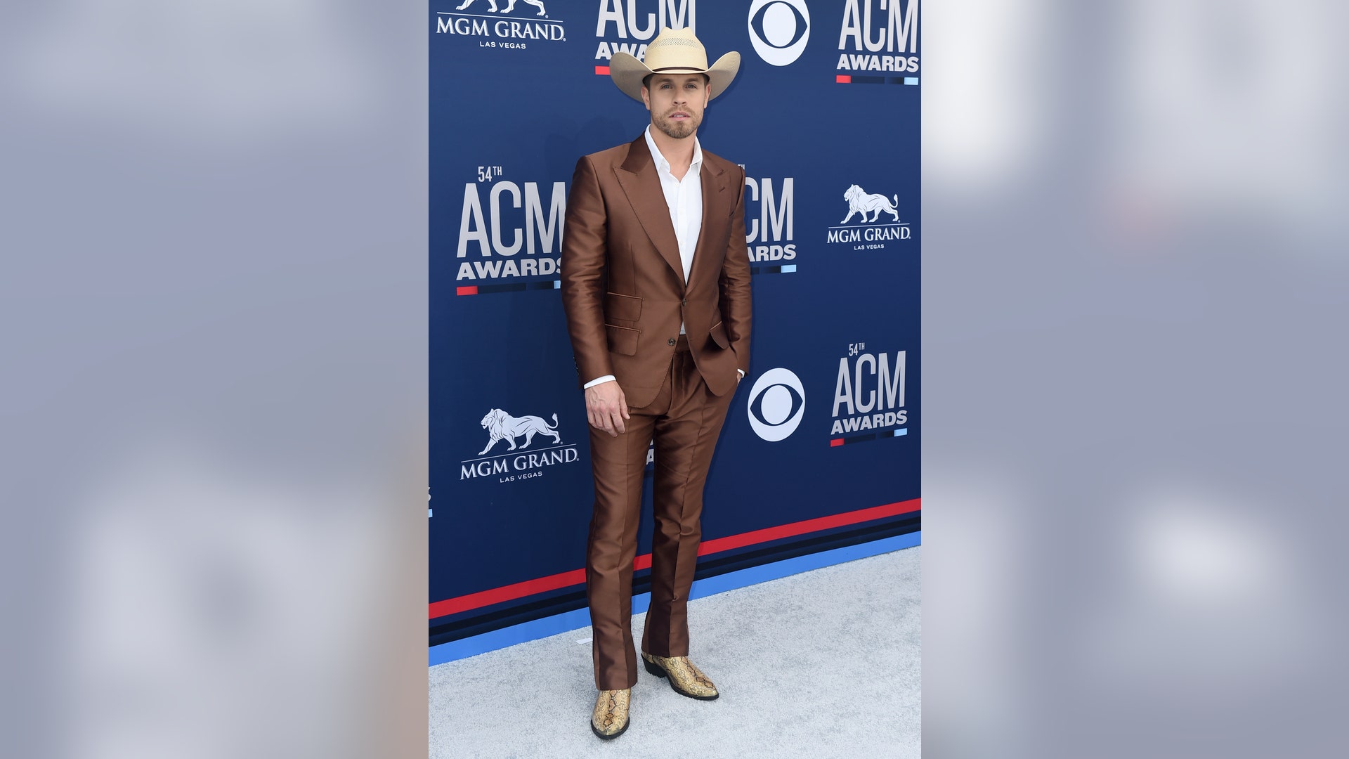 Dustin Lynch looks dapper in an all brown suit with matching gold snakeskin boots.